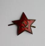 Red star on his cap/hat.